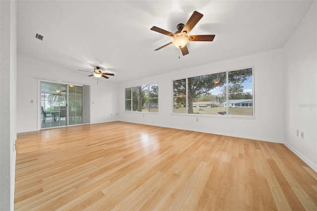 unfurnished room with light wood finished floors, ceiling fan, visible vents, and baseboards