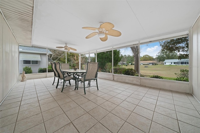 unfurnished sunroom featuring a healthy amount of sunlight and a ceiling fan