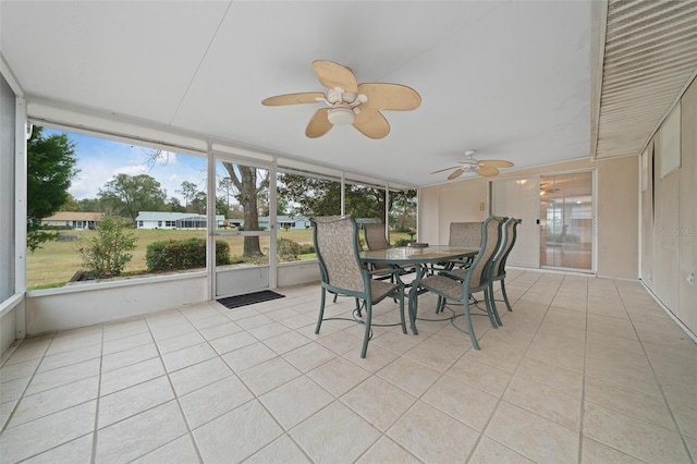 unfurnished sunroom with ceiling fan