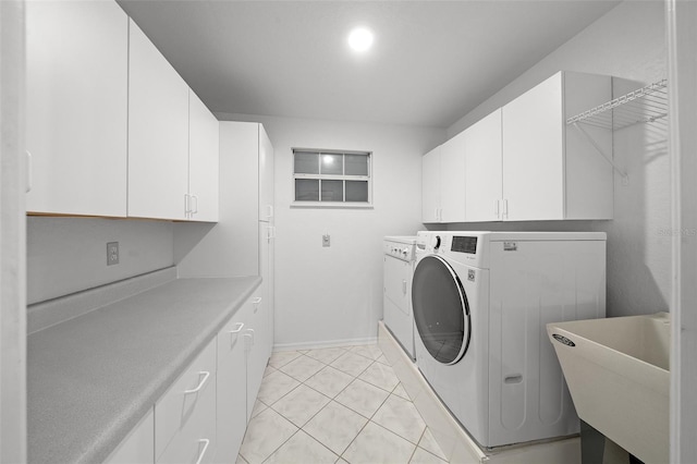 clothes washing area with cabinet space, washer / clothes dryer, a sink, and light tile patterned flooring