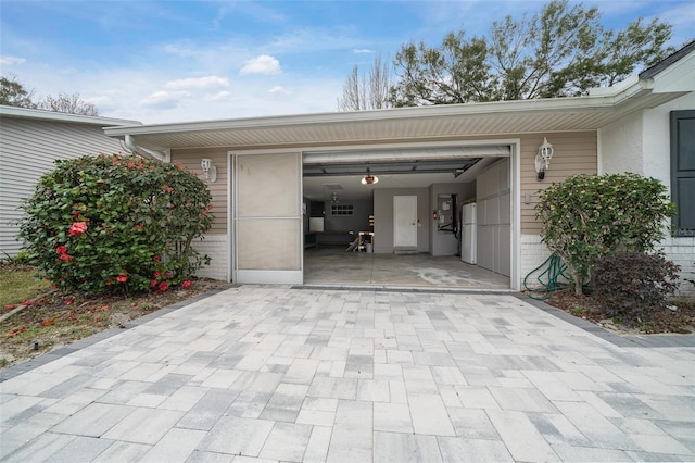 garage featuring decorative driveway