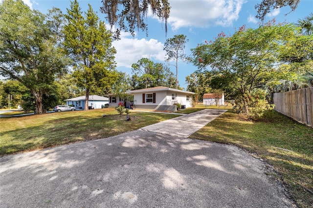 ranch-style home with a front lawn