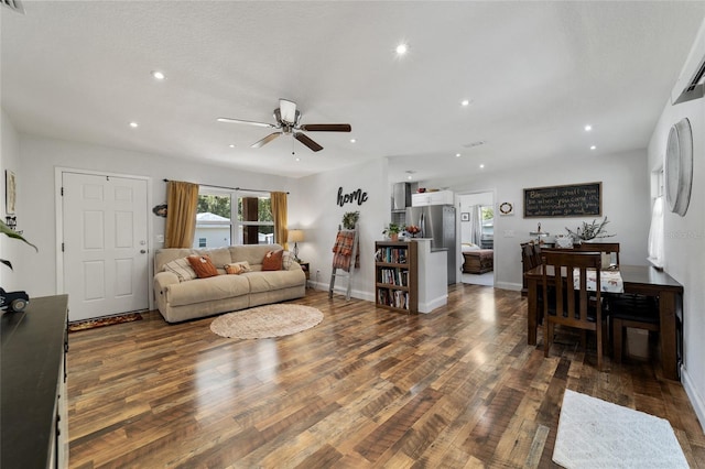 living room with ceiling fan and dark hardwood / wood-style flooring