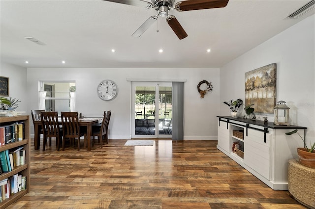 dining area with ceiling fan and dark hardwood / wood-style floors