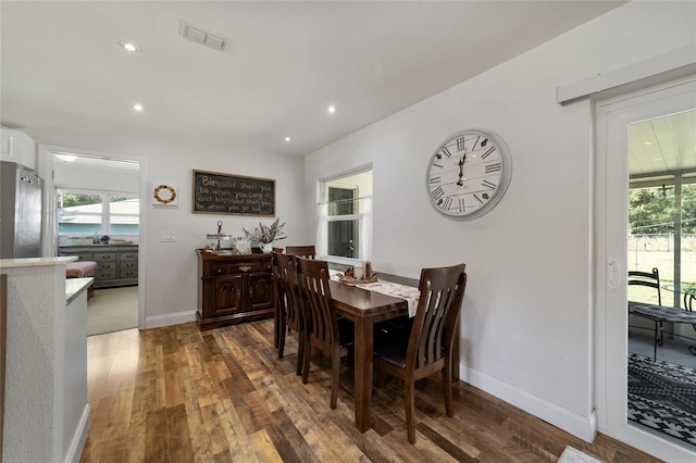 dining space with dark hardwood / wood-style floors