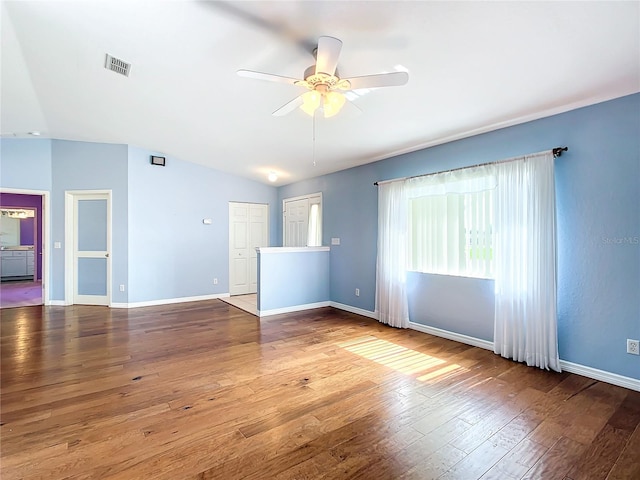 spare room with hardwood / wood-style flooring, ceiling fan, and lofted ceiling