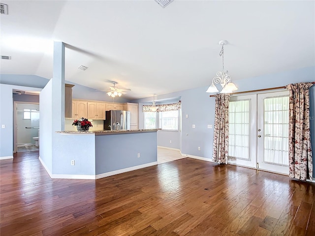 kitchen with french doors, dark hardwood / wood-style flooring, stainless steel refrigerator with ice dispenser, lofted ceiling, and ceiling fan with notable chandelier