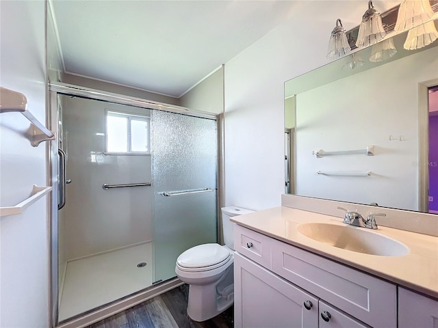 bathroom featuring hardwood / wood-style floors, vanity, an enclosed shower, and toilet