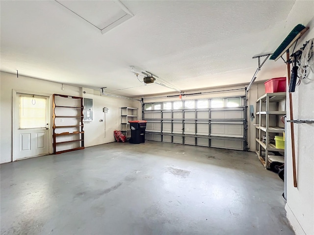 garage with a garage door opener and electric panel