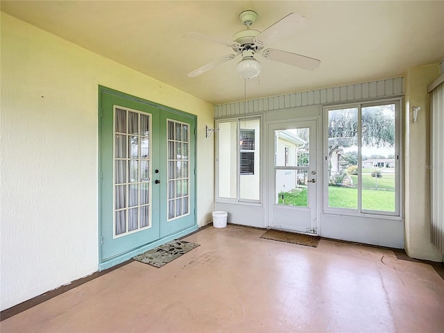 unfurnished sunroom with french doors and ceiling fan