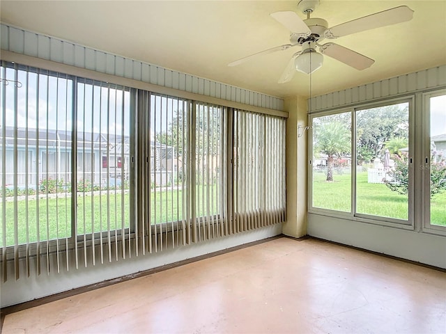 unfurnished sunroom featuring ceiling fan