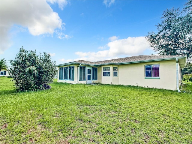 view of front of property with a sunroom and a front lawn