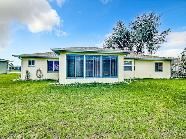 rear view of property with a lawn