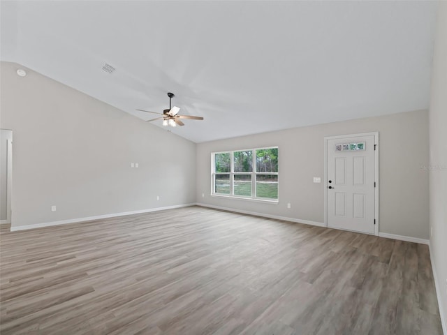 unfurnished living room featuring light hardwood / wood-style floors, vaulted ceiling, and ceiling fan