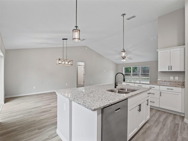 kitchen with dishwasher, a center island with sink, sink, vaulted ceiling, and white cabinetry