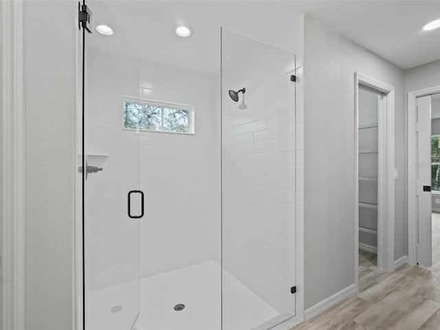 bathroom featuring walk in shower and hardwood / wood-style flooring