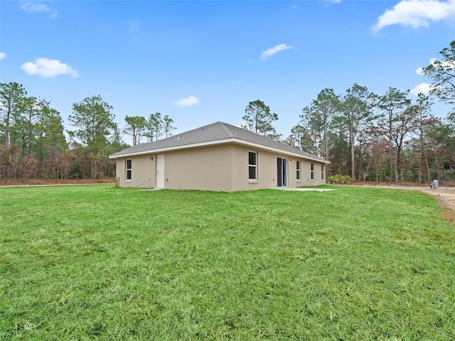 back of property featuring a lawn