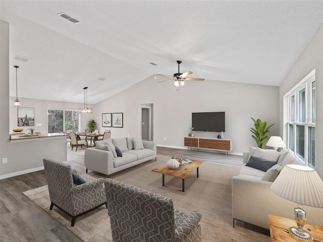 living room featuring hardwood / wood-style floors, ceiling fan, and lofted ceiling