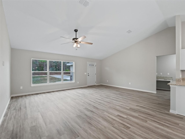 unfurnished living room featuring vaulted ceiling, light hardwood / wood-style flooring, and ceiling fan