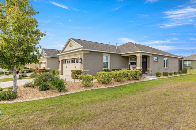 single story home with a garage and a front lawn