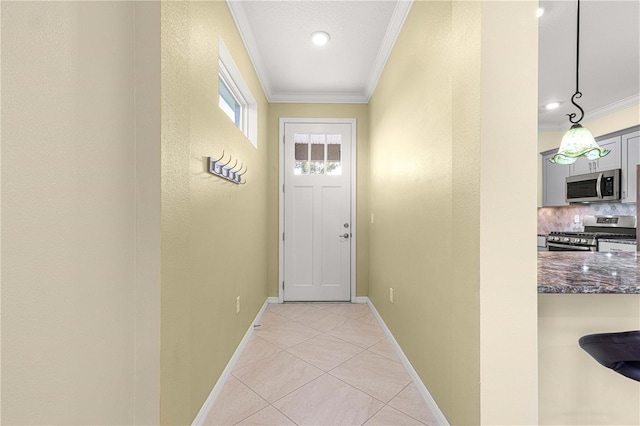 entryway with crown molding and light tile patterned floors