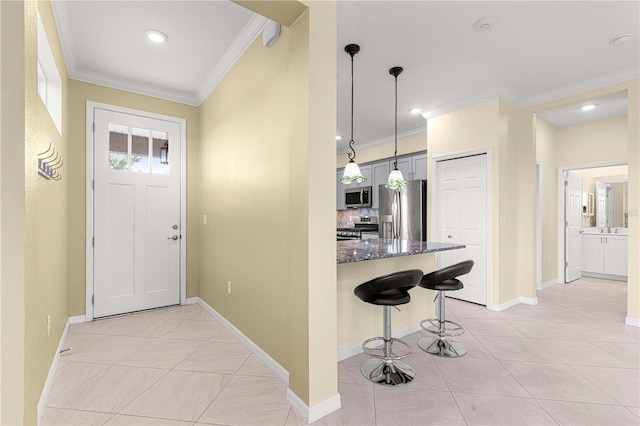 entrance foyer featuring crown molding and light tile patterned flooring