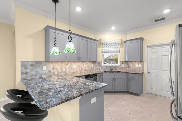 kitchen with dark stone counters, sink, tasteful backsplash, decorative light fixtures, and stainless steel appliances