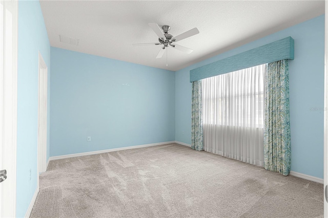 unfurnished room with ceiling fan and light colored carpet