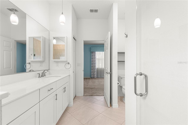 bathroom with tile patterned floors, vanity, and toilet