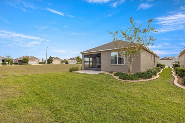 back of property with a yard and a sunroom