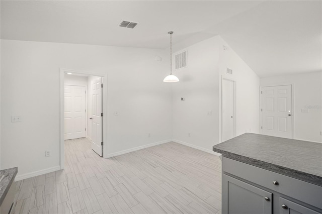 unfurnished living room with light hardwood / wood-style flooring and lofted ceiling