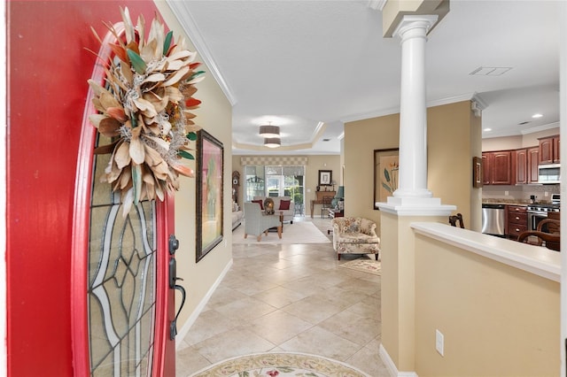 entryway featuring light tile patterned flooring, ornamental molding, and ornate columns