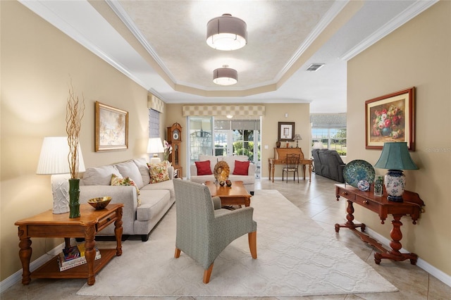 living room with a tray ceiling, crown molding, and light tile patterned flooring