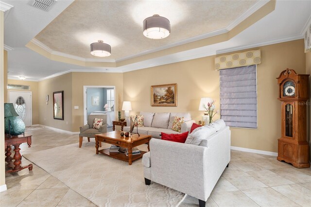 tiled living room featuring a raised ceiling and ornamental molding