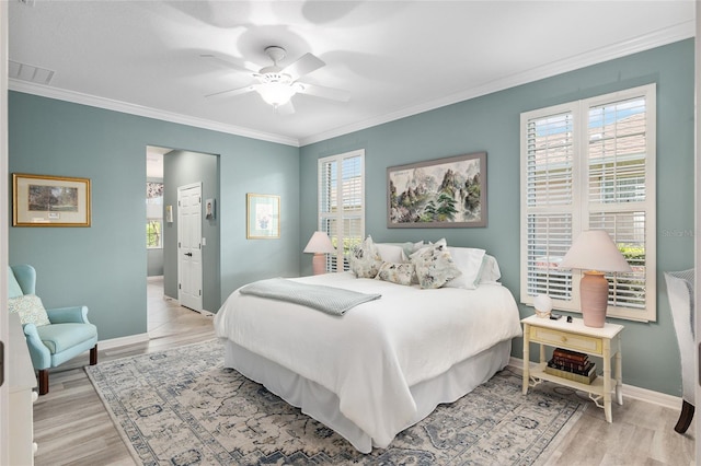 bedroom featuring ceiling fan, light hardwood / wood-style floors, and ornamental molding