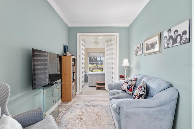 living room with light wood-type flooring and ornamental molding