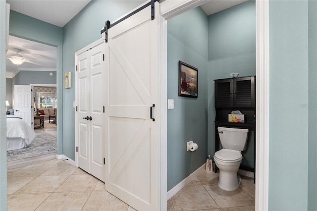 bathroom with tile patterned flooring, ceiling fan, toilet, and ornamental molding