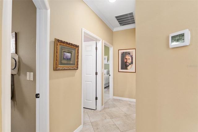 hallway with crown molding and light tile patterned flooring