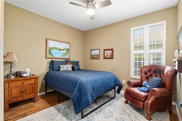 bedroom with ceiling fan and light hardwood / wood-style flooring