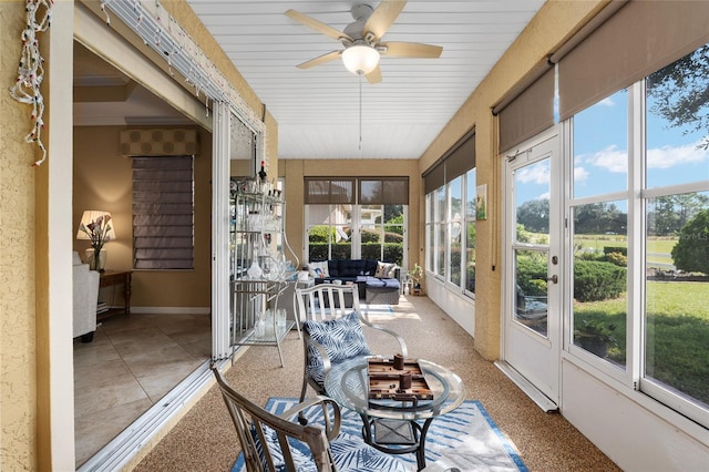 sunroom / solarium featuring ceiling fan and plenty of natural light