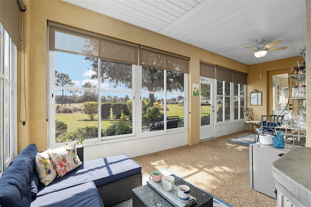 sunroom / solarium featuring ceiling fan