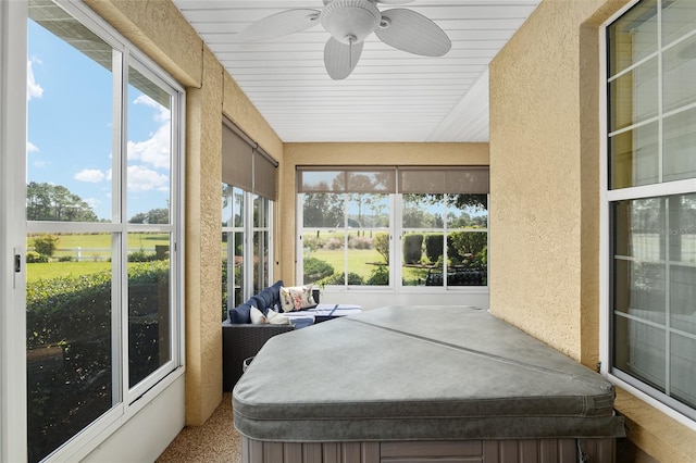 sunroom featuring a jacuzzi and ceiling fan