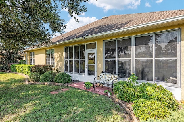 back of property featuring a lawn