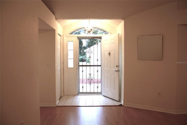 foyer featuring a notable chandelier and light wood-type flooring