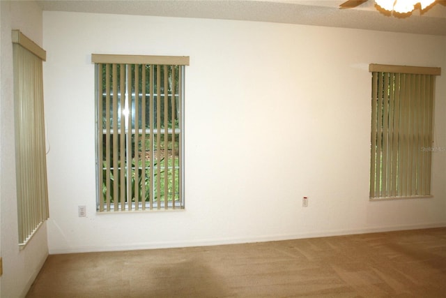 carpeted empty room featuring ceiling fan