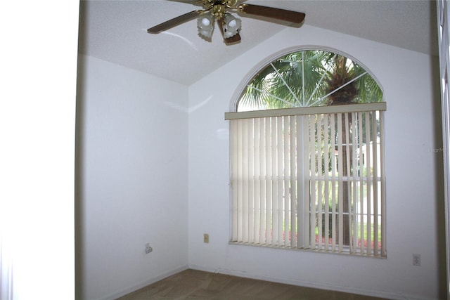 unfurnished room with a textured ceiling, ceiling fan, wood-type flooring, and lofted ceiling