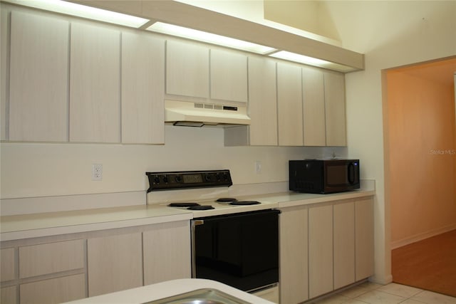 kitchen with light tile patterned flooring, white electric range, and range hood