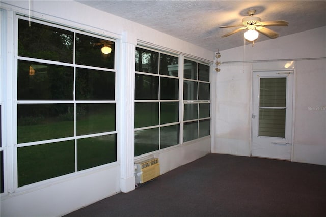 unfurnished sunroom with ceiling fan and lofted ceiling