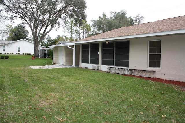 rear view of property with a yard