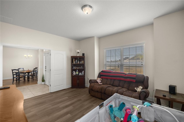 living room featuring an inviting chandelier and light hardwood / wood-style flooring